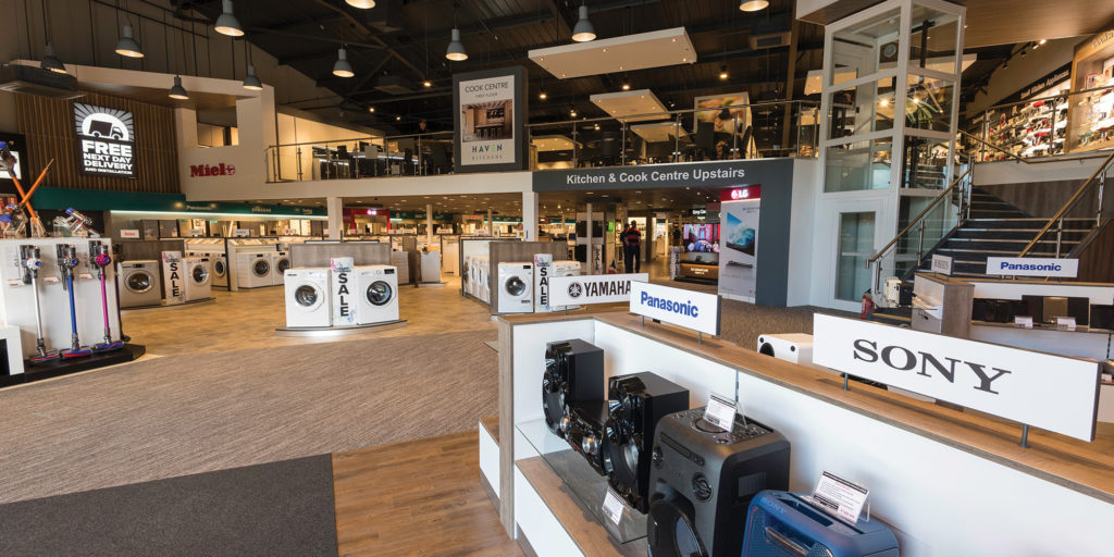 Interior of a modern electrical showroom, with home appliances, televisions, audio equipment and kitchen displays.